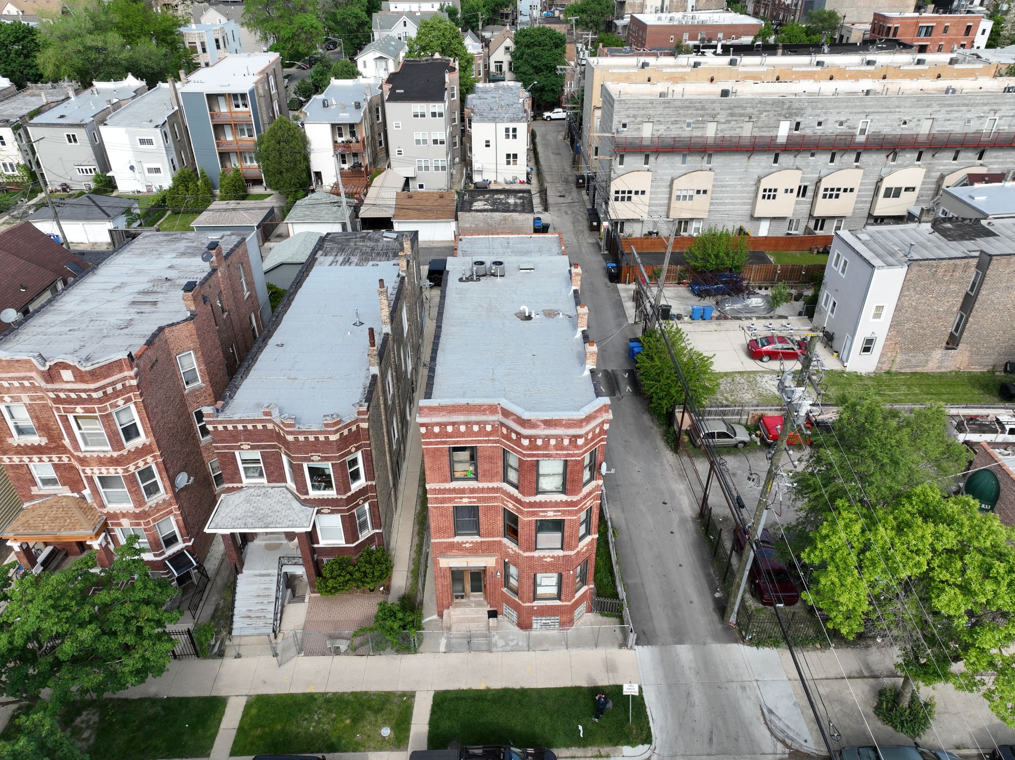 Aerial photograph of a brick three-flat in Chicago, shot from directly overhead the street.